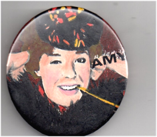 A large pin with art of Amy on it